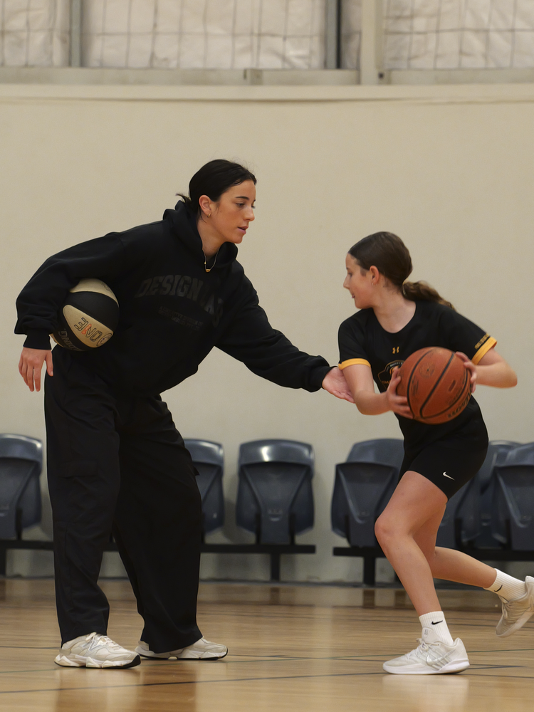 Chloe coaching a young WABL player on defense